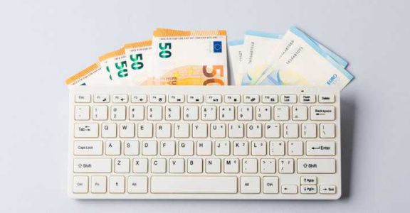 Euro money banknotes under keyboard, online banking, sale of digital info products concept. Financial online investment, trading, income earnings concept, banner