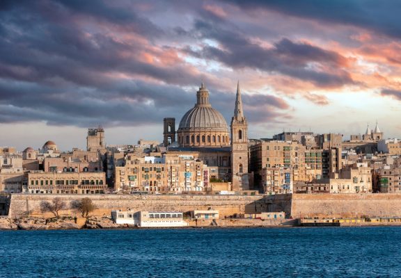 Valletta, Malta, Skyline in the afternoon with the dome of the Carmelite Church and the tower of St Paul`s, cloudy sky background